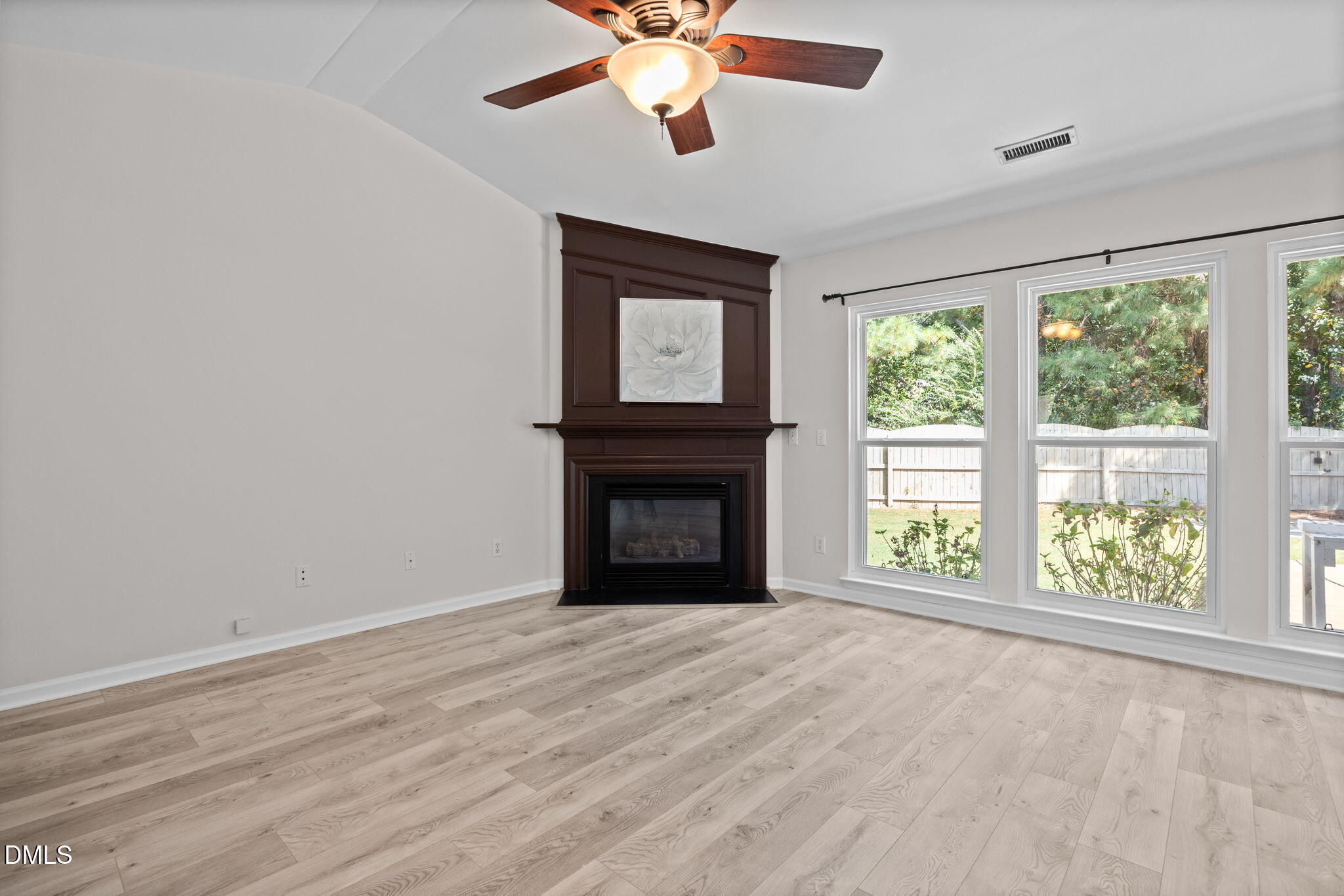 104 Saddle River Road Apex, NC 27502 - Photo 6 of 42 a view of an empty room with a window and a fireplace