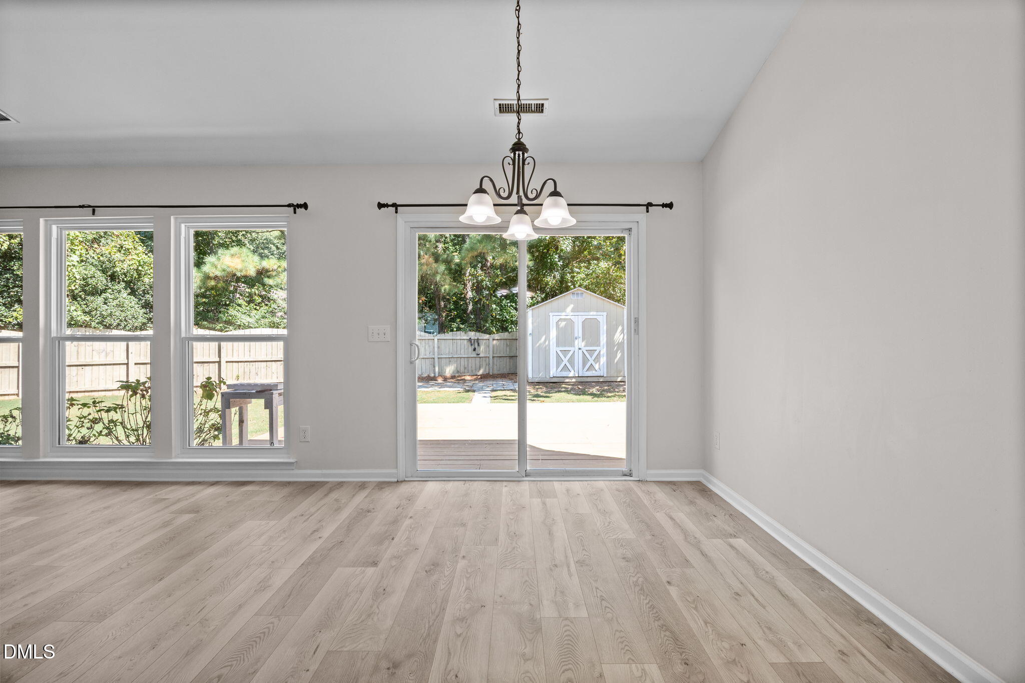 104 Saddle River Road Apex, NC 27502 - Photo 7 of 42 a view of a room with wooden floor exposed radiator and windows