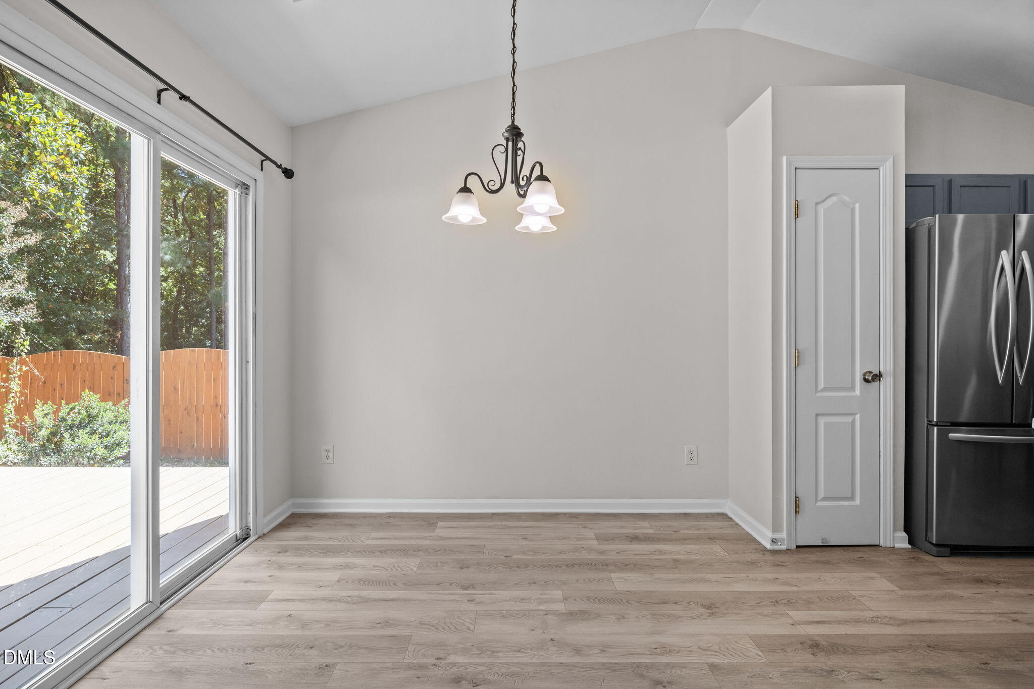 104 Saddle River Road Apex, NC 27502 - Photo 8 of 42 a view of a livingroom with wooden floor a ceiling fan and a living room