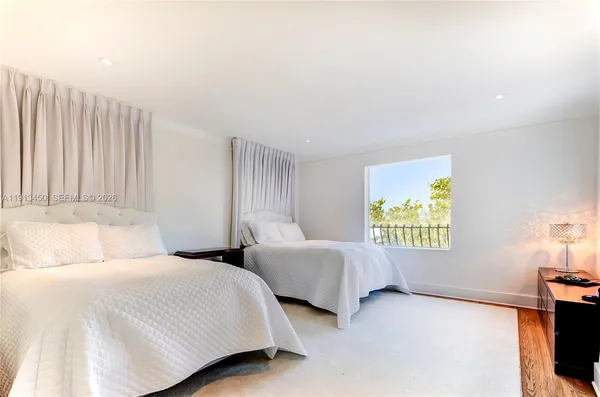 a bedroom with two beds and painting on the wall