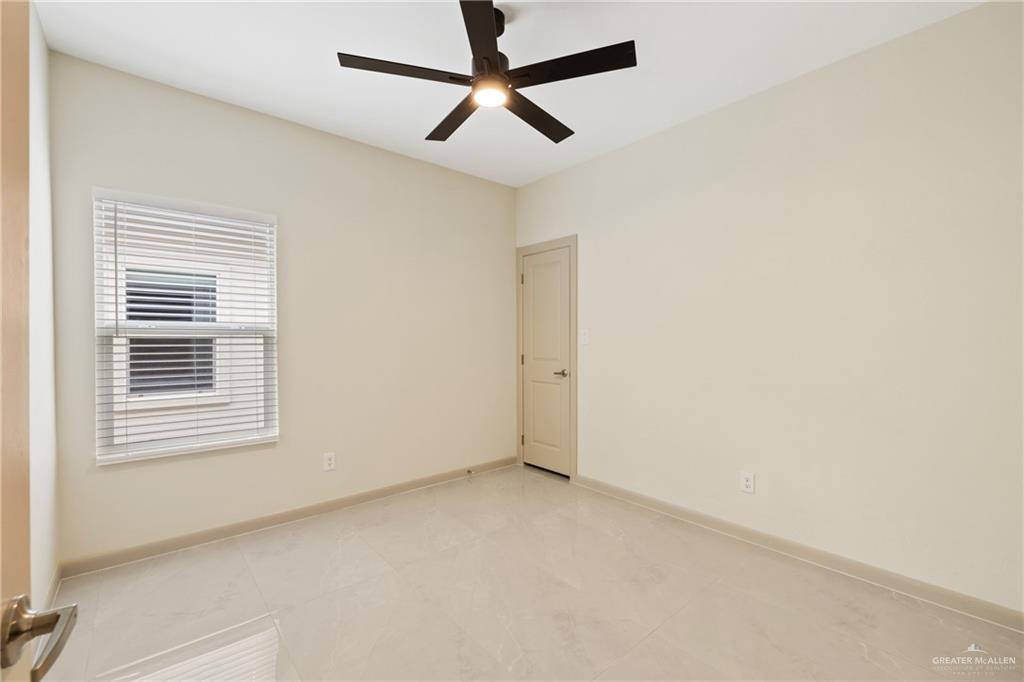 1806 West Violet Drive, Unit 3 Pharr, TX 78577 - Photo 10 of 15 an empty room with a window and a fan