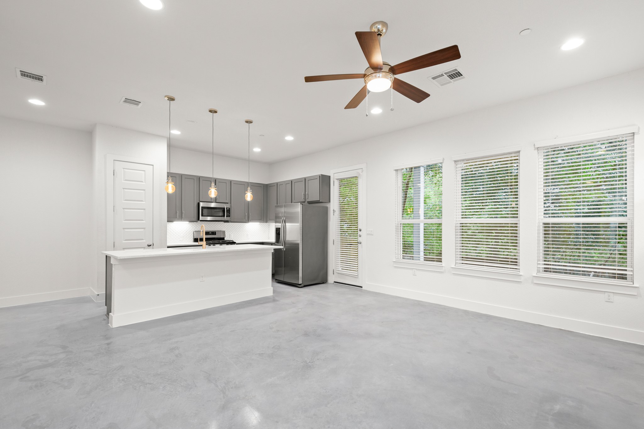 8922 Manchaca Road, Unit 701 Austin, TX 78748 - Photo 2 of 25 a living room with stainless steel appliances kitchen island furniture and a large window