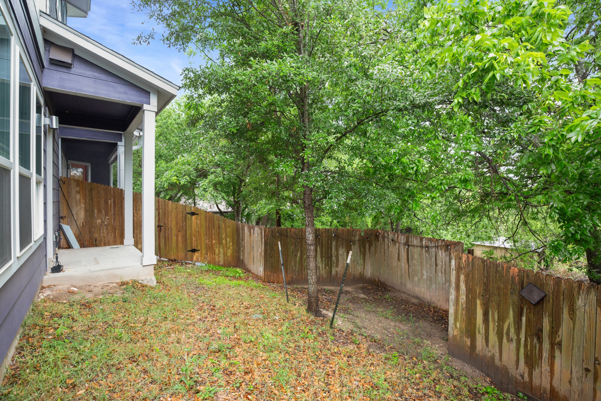 8922 Manchaca Road, Unit 701 Austin, TX 78748 - Photo 24 of 25 a backyard of a house with trees and wooden fence