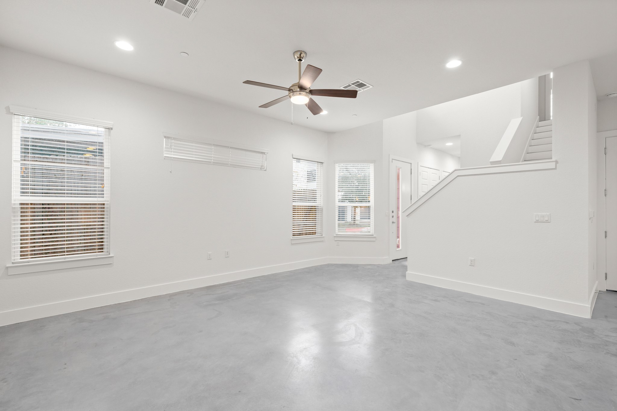 8922 Manchaca Road, Unit 701 Austin, TX 78748 - Photo 4 of 25 an empty room with windows and ceiling fan