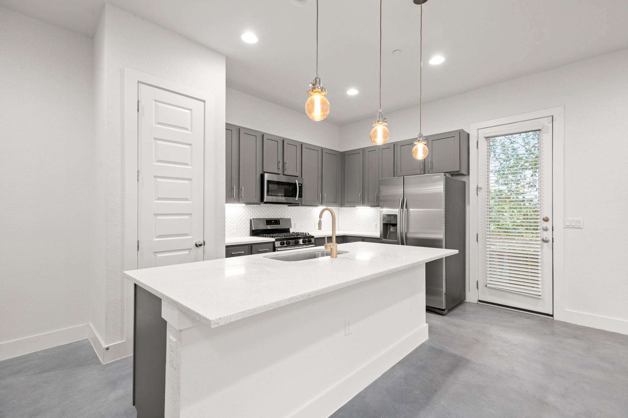 8922 Manchaca Road, Unit 701 Austin, TX 78748 - Photo 6 of 25 a kitchen with a sink a stove a refrigerator a center island a stove and a window