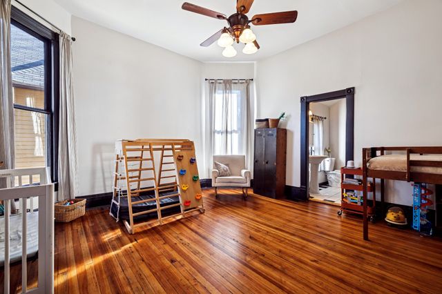 a view of a livingroom with wooden floor and a fireplace