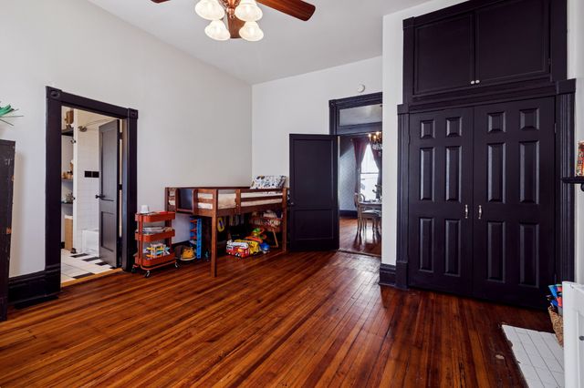 a living room with furniture and a book shelf