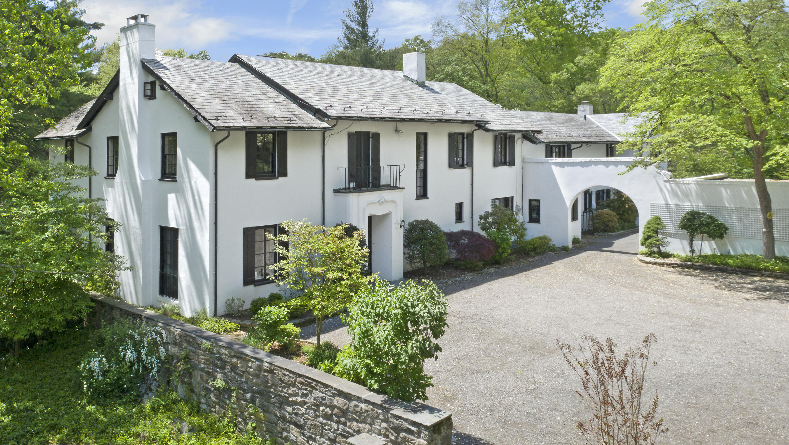 684 Westover Road Stamford, CT 06902 - Photo 1 of 25 a view of a white house with a small yard plants and a large tree