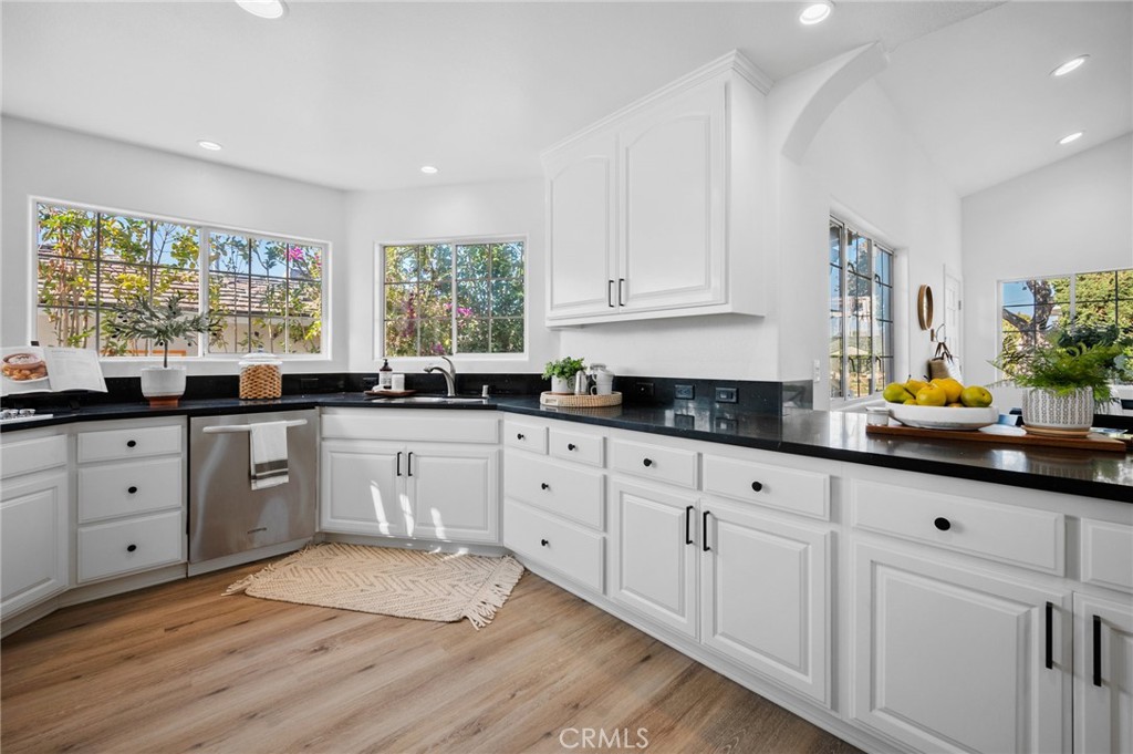 101 Esplanade San Clemente, CA 92672 - Photo 10 of 39 a kitchen with white cabinets a window a sink and white appliances