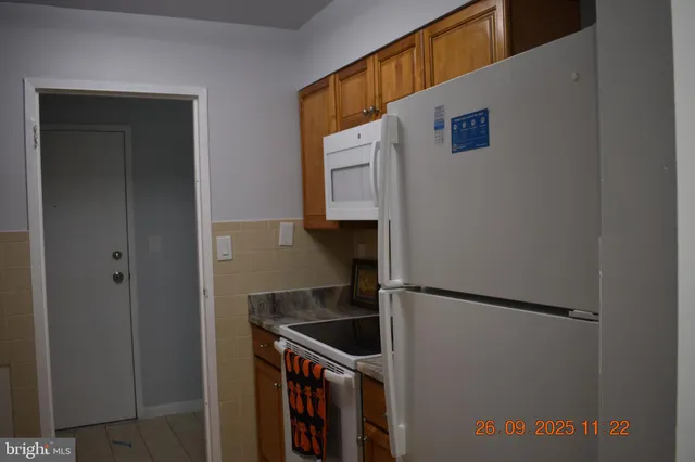 a kitchen with a stove and a refrigerator