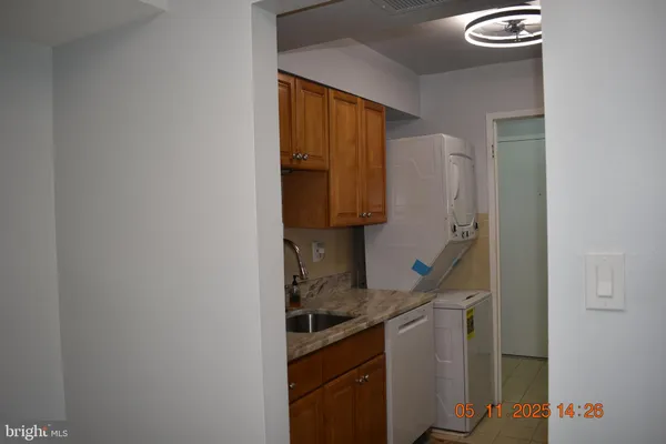 a kitchen with a refrigerator and a stove top oven