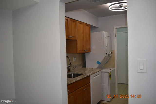 a kitchen with a refrigerator and a stove top oven