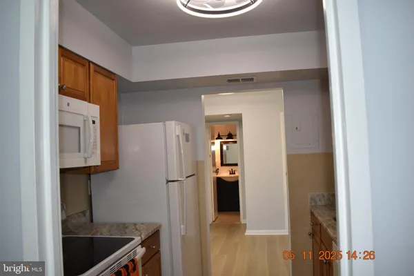 a kitchen with a refrigerator and a sink