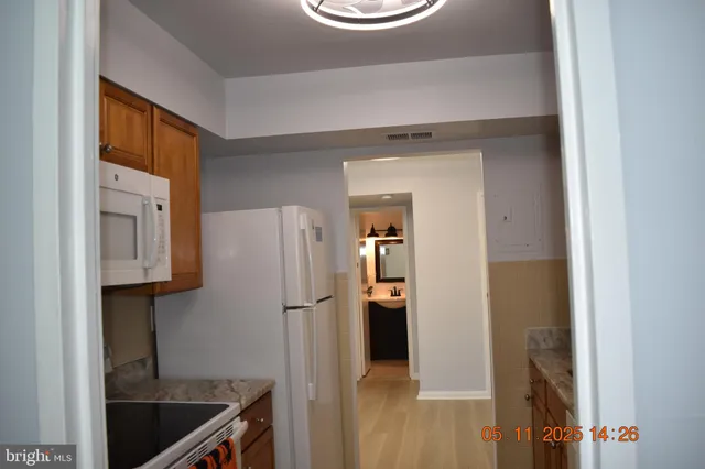 a kitchen with a refrigerator and a sink