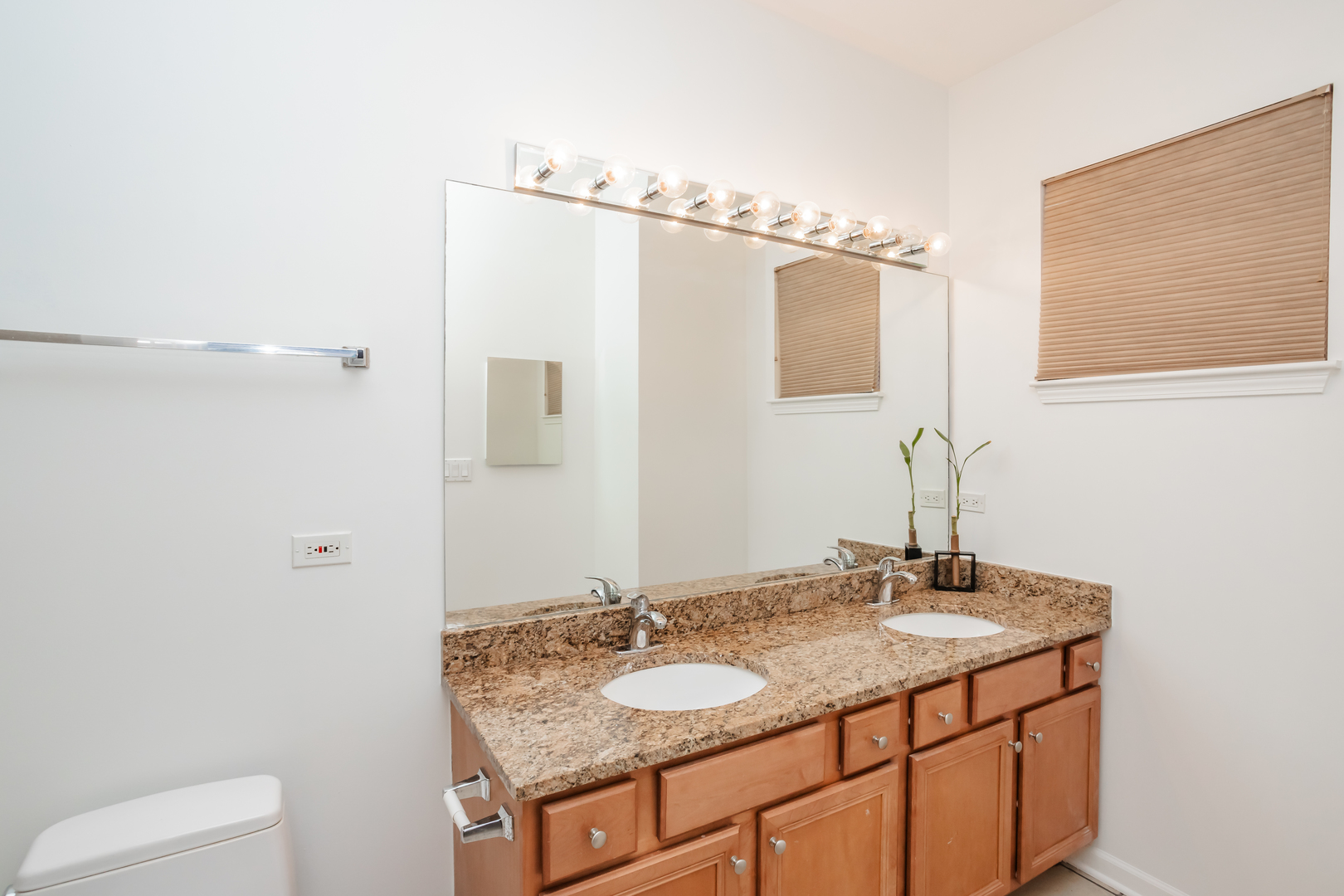 1418 South Halsted Street, Unit 1A Chicago, IL 60607 - Photo 12 of 19 a bathroom with a granite countertop sink and a mirror