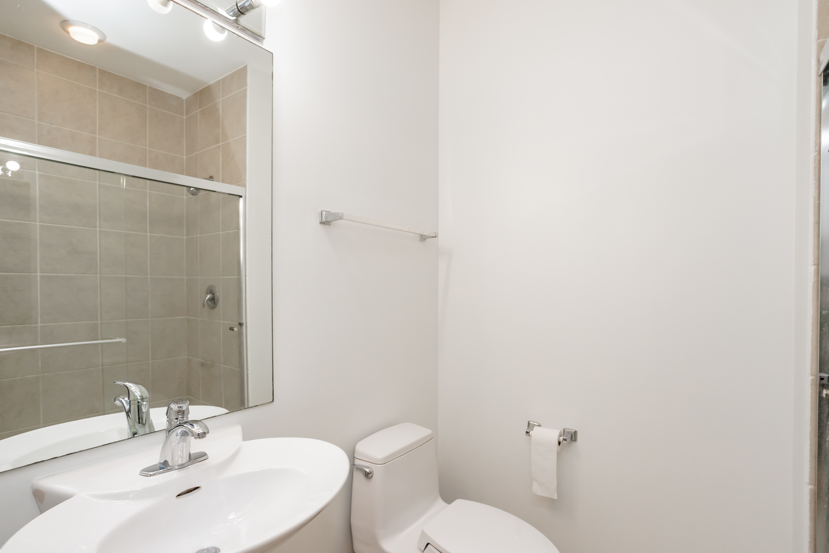 1418 South Halsted Street, Unit 1A Chicago, IL 60607 - Photo 13 of 19 a bathroom with a sink a toilet and a mirror