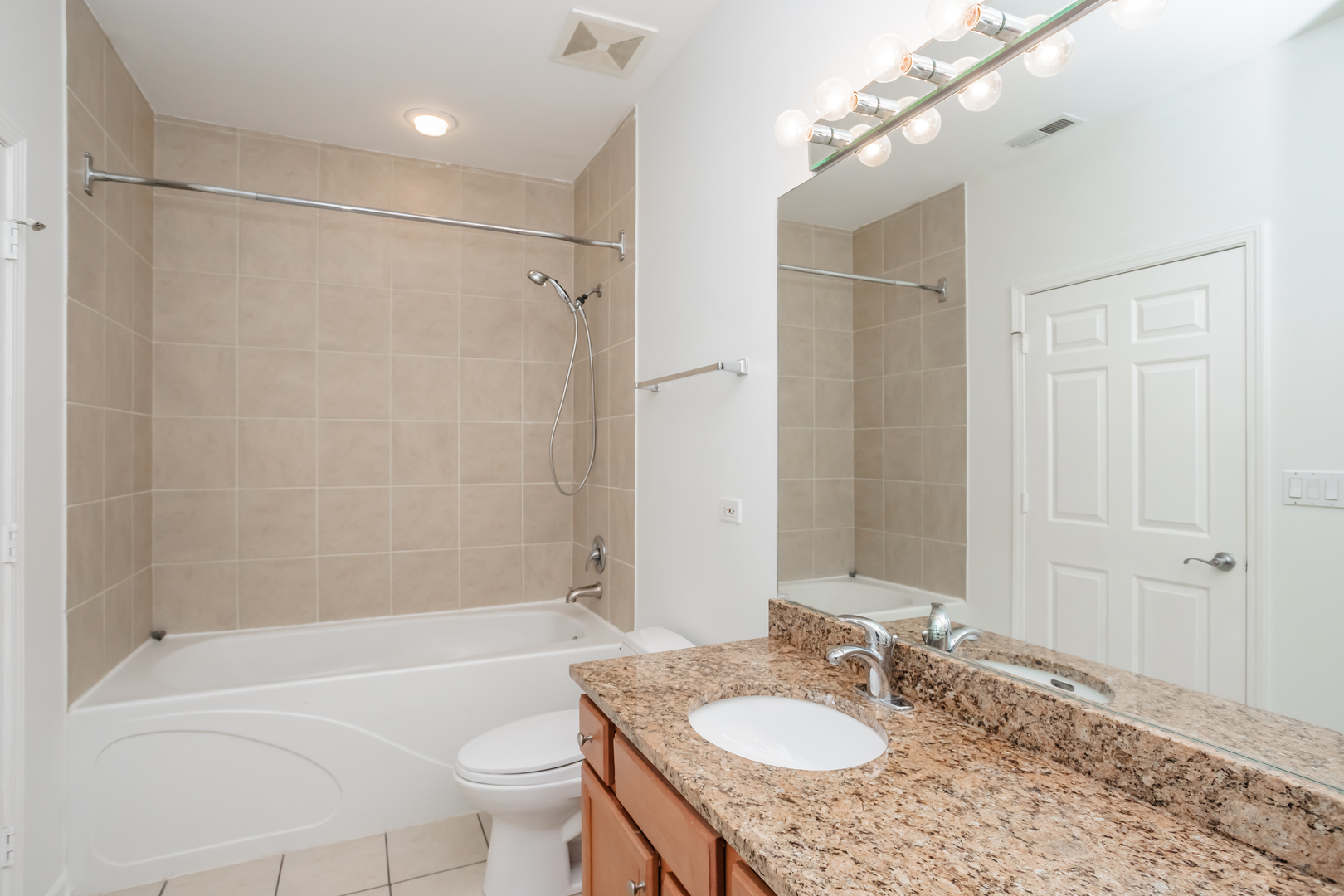 1418 South Halsted Street, Unit 1A Chicago, IL 60607 - Photo 4 of 19 a bathroom with a granite countertop sink toilet and shower