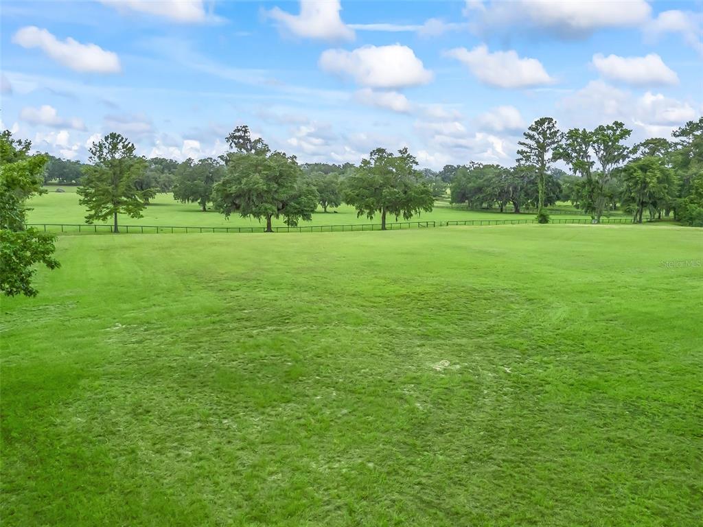 84rd Terrace Northwest Ocala, FL 34482 - Photo 11 of 14 a view of a green field with wooden fence