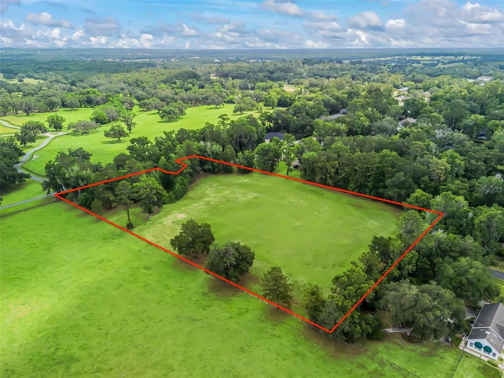 84rd Terrace Northwest Ocala, FL 34482 - Photo 8 of 14 a view of a lush green outdoor space with a swimming pool and valleys in the background