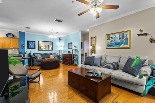 a living room with furniture floor to ceiling window and a flat screen tv