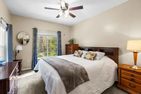 a bedroom with a large bed and a large window
