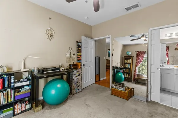 a view of a workspace with furniture and a window