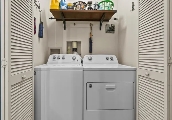 a living room with furniture a dining table and kitchen view