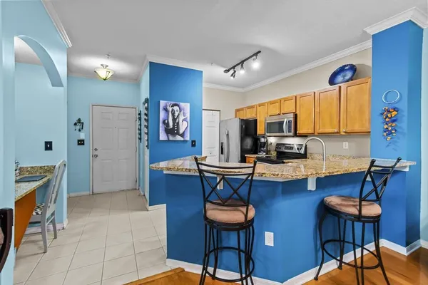 a kitchen with stainless steel appliances granite countertop a sink and cabinets