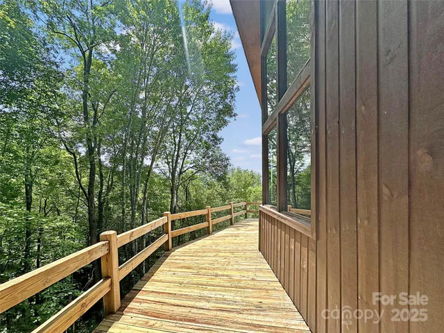 a view of balcony with wooden floor and fence