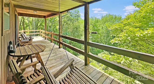 a view of balcony with wooden floor and fence