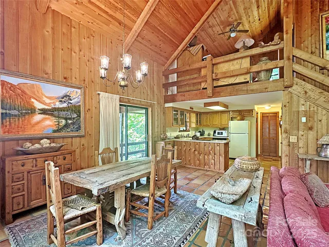 a dining room with furniture a rug and wooden floor