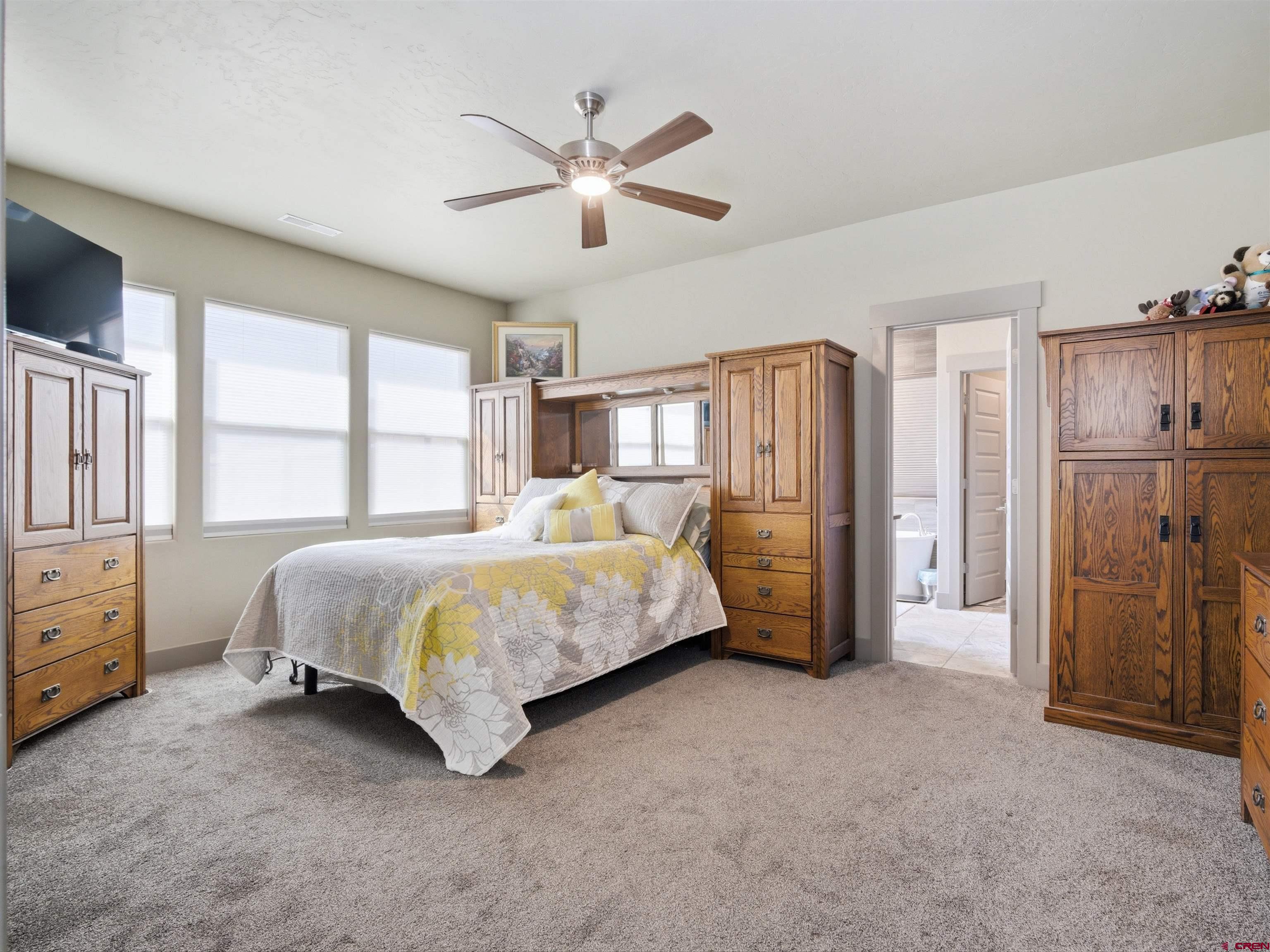 1223 Eagle Way Fruita, CO 81521 - Photo 13 of 34 a bed room with a bed and a ceiling fan