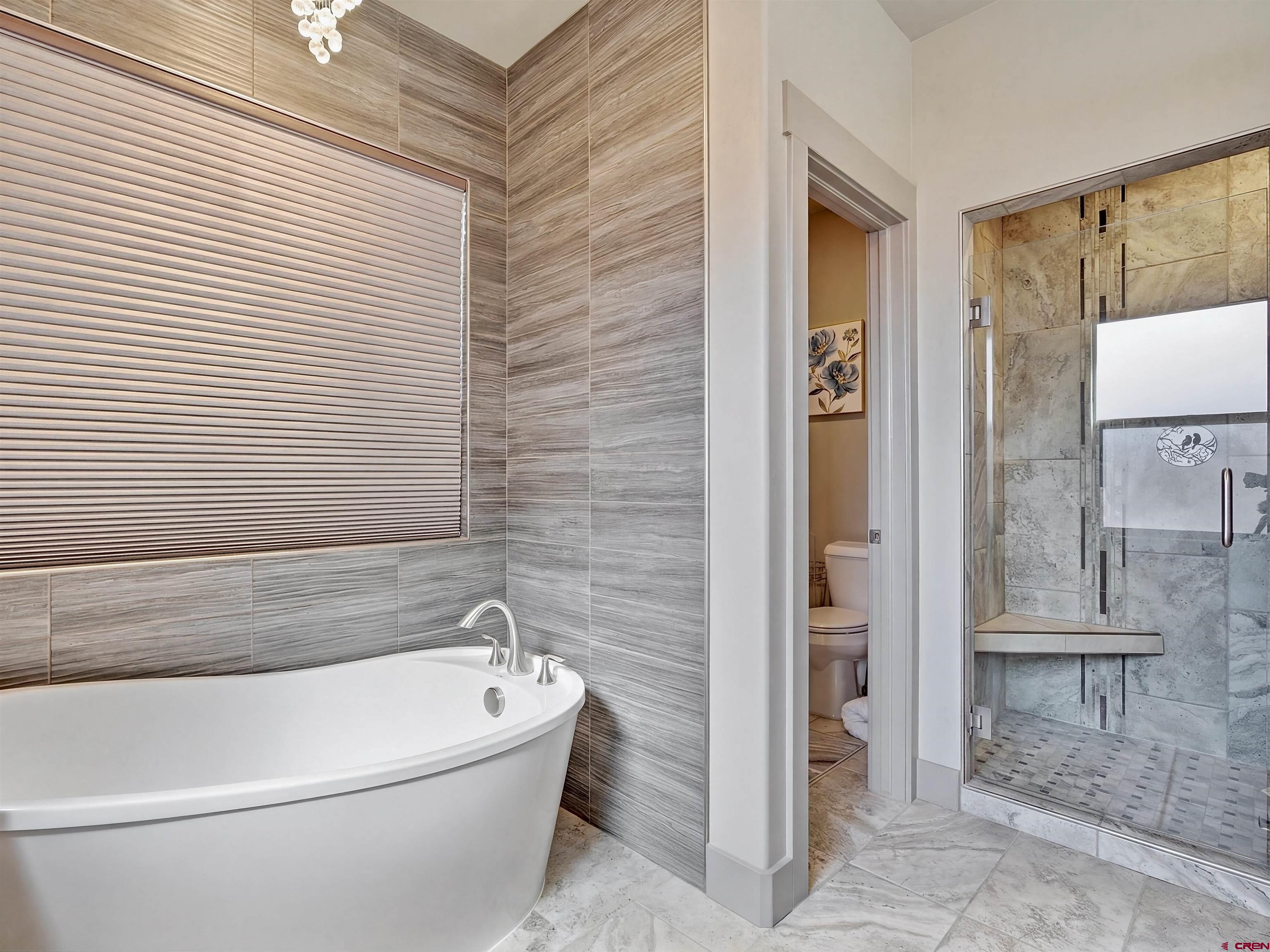 1223 Eagle Way Fruita, CO 81521 - Photo 16 of 34 a white bath tub sitting next to a shower