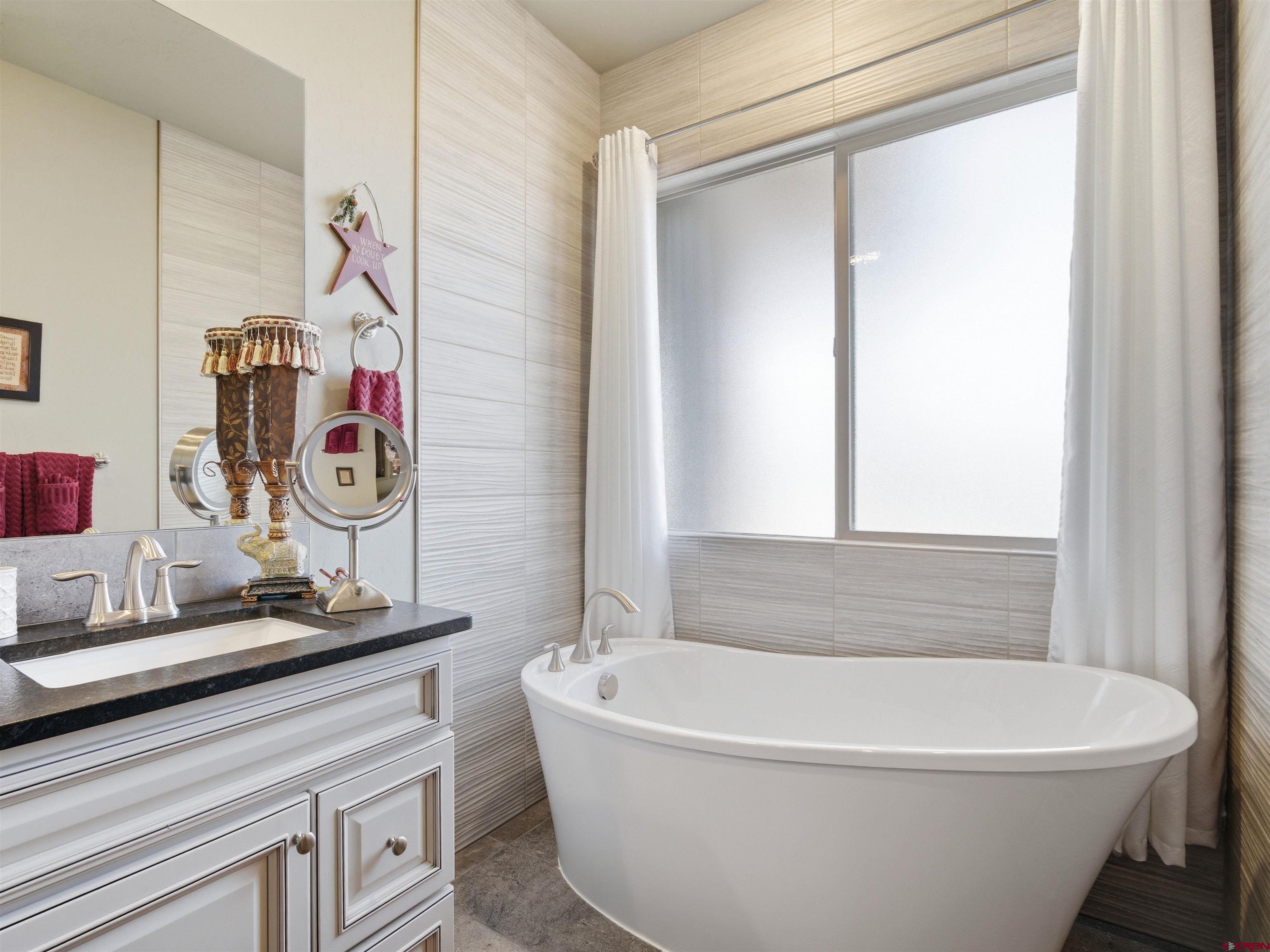 1223 Eagle Way Fruita, CO 81521 - Photo 19 of 34 a white bath tub sitting next to a white sink