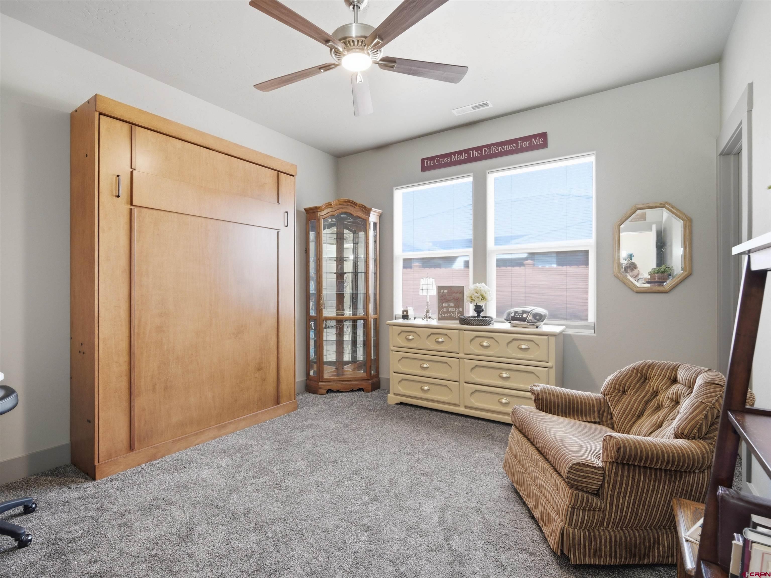 1223 Eagle Way Fruita, CO 81521 - Photo 21 of 34 a living room with furniture and a large window
