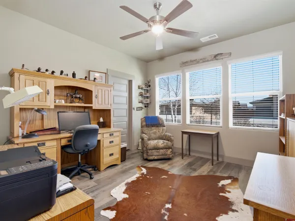 a livingroom with workspace and a window