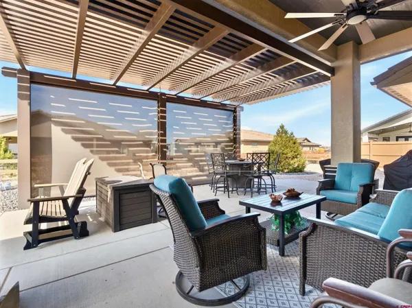 a view of a patio with table and chairs