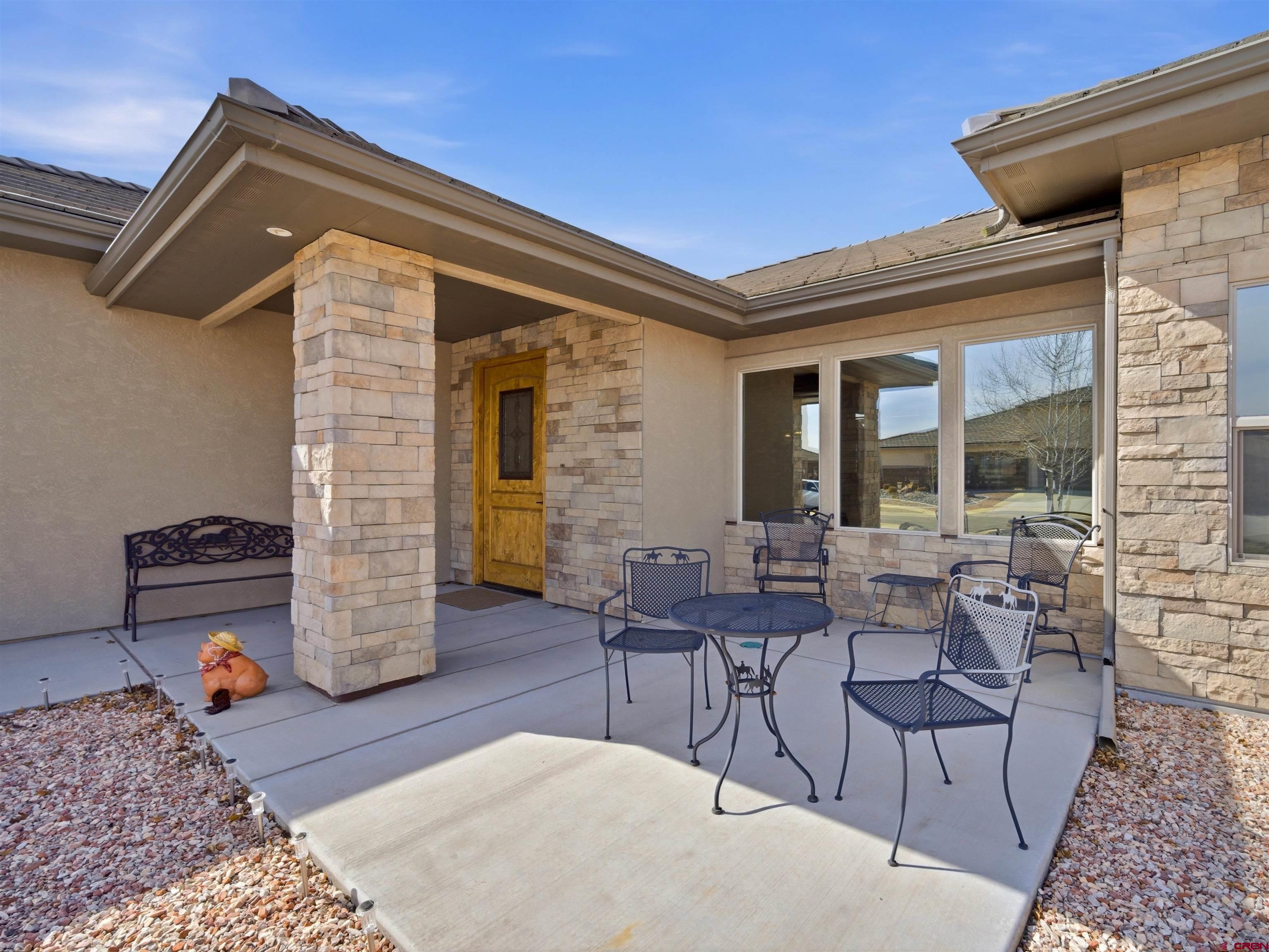 1223 Eagle Way Fruita, CO 81521 - Photo 4 of 34 a outdoor space with patio the couches and a dining table with chairs