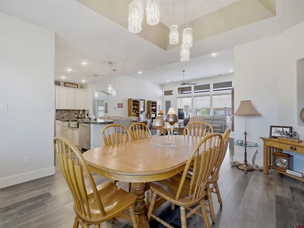 a dining room with furniture and wooden floor