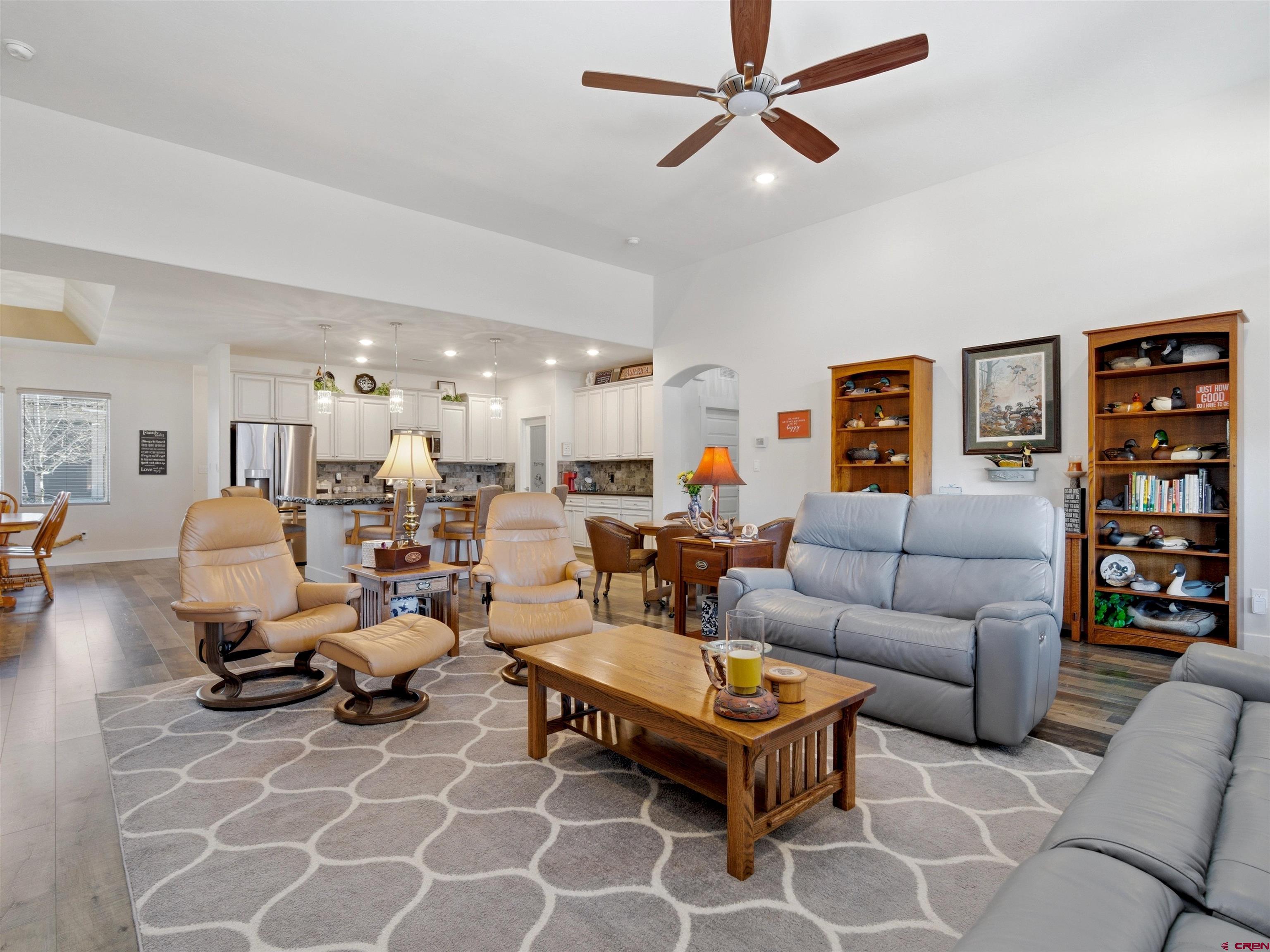 1223 Eagle Way Fruita, CO 81521 - Photo 10 of 34 a living room with furniture a rug and a bookshelf