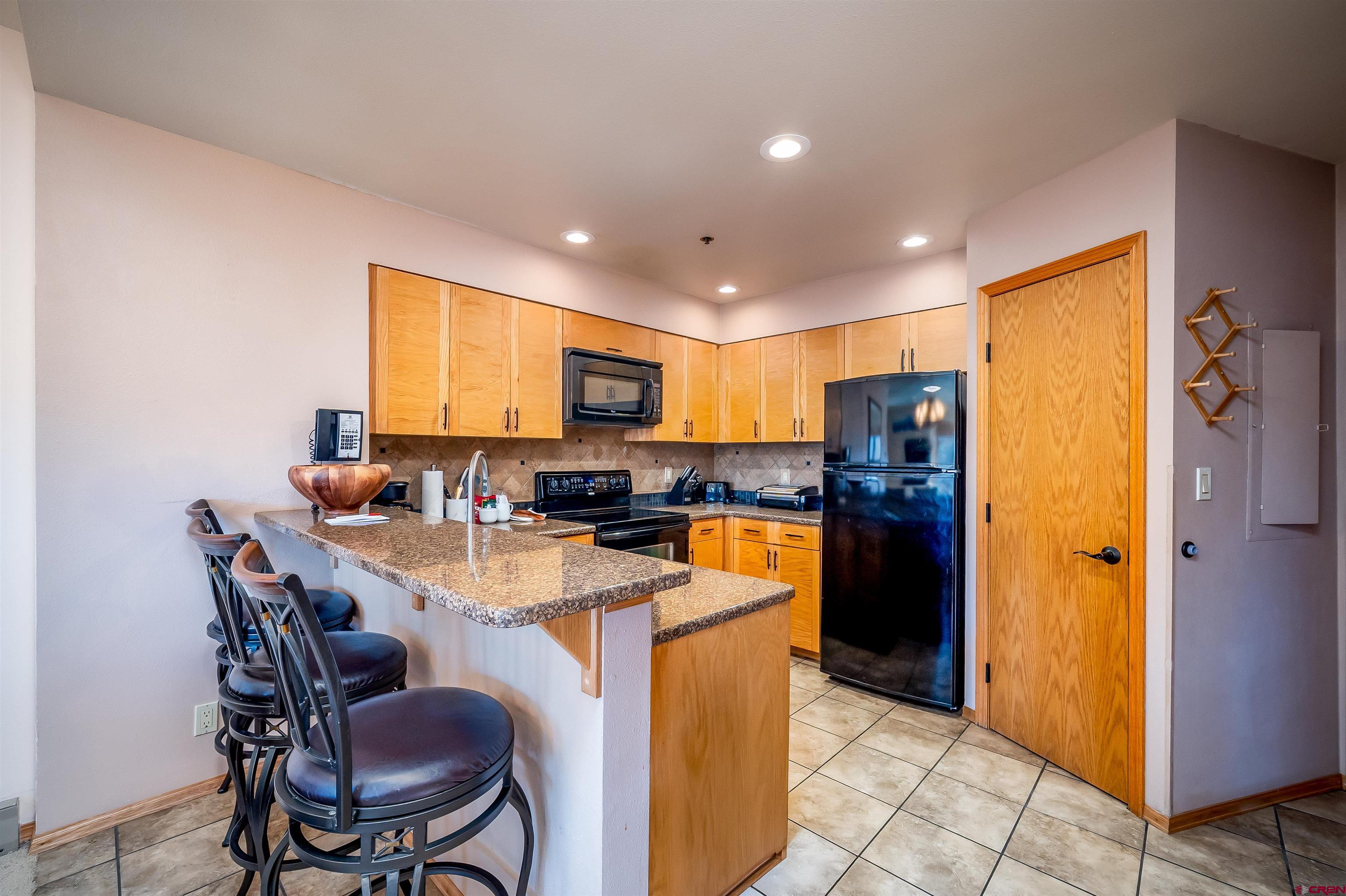 71 East Needles Road, Unit 337 Durango, CO 81301 - Photo 3 of 45 a kitchen with stainless steel appliances a refrigerator a stove a sink a dining table and chairs