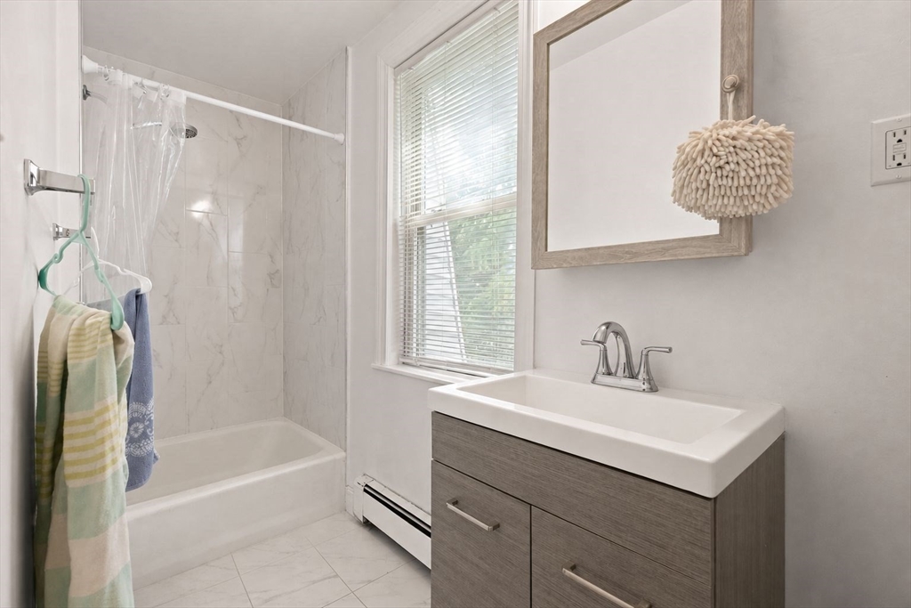 39 Union Street Boston, MA 02135 - Photo 14 of 33 a bathroom with a sink a vanity and a bathtub