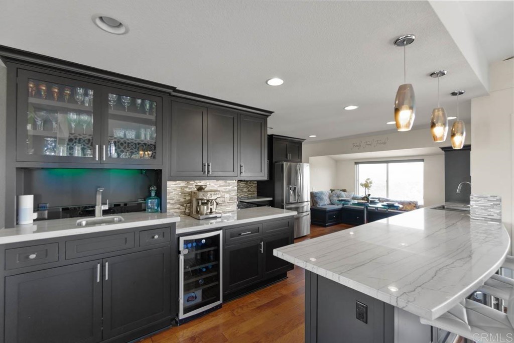 777 Phoenix Way San Marcos, CA 92078 - Photo 11 of 75 a kitchen with a stove a sink a refrigerator and chairs
