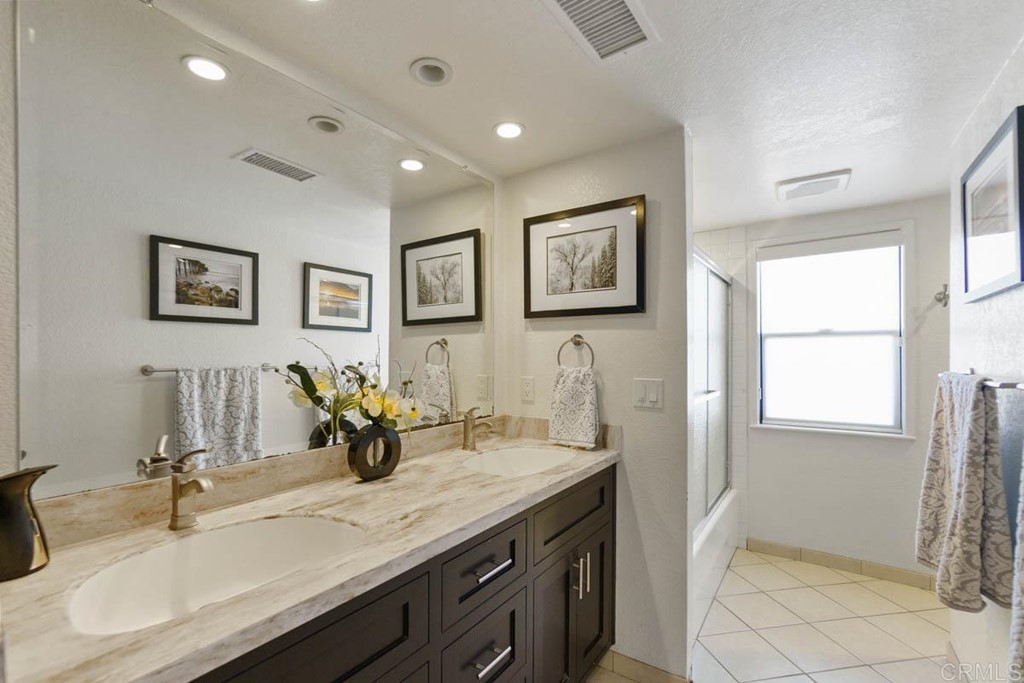 777 Phoenix Way San Marcos, CA 92078 - Photo 28 of 75 a bathroom with double vanity sinks a mirror and painting on the wall