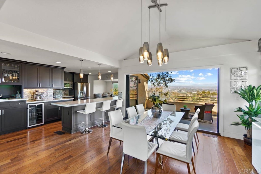 777 Phoenix Way San Marcos, CA 92078 - Photo 10 of 75 a view of a dining room and livingroom with furniture wooden floor a chandelier