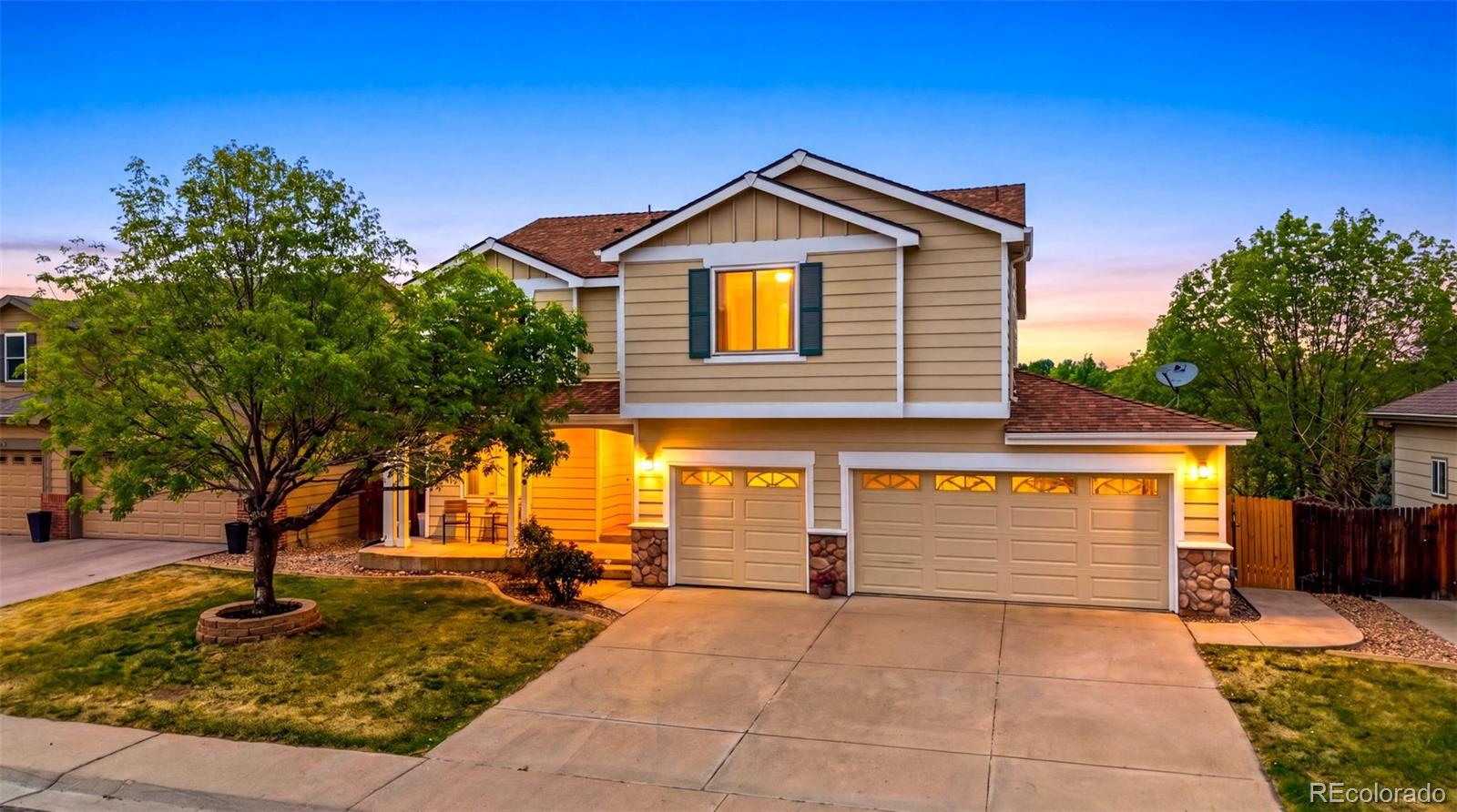3033 East 108th Drive Northglenn, CO 80233 - Photo 1 of 50 a front view of a house with garden