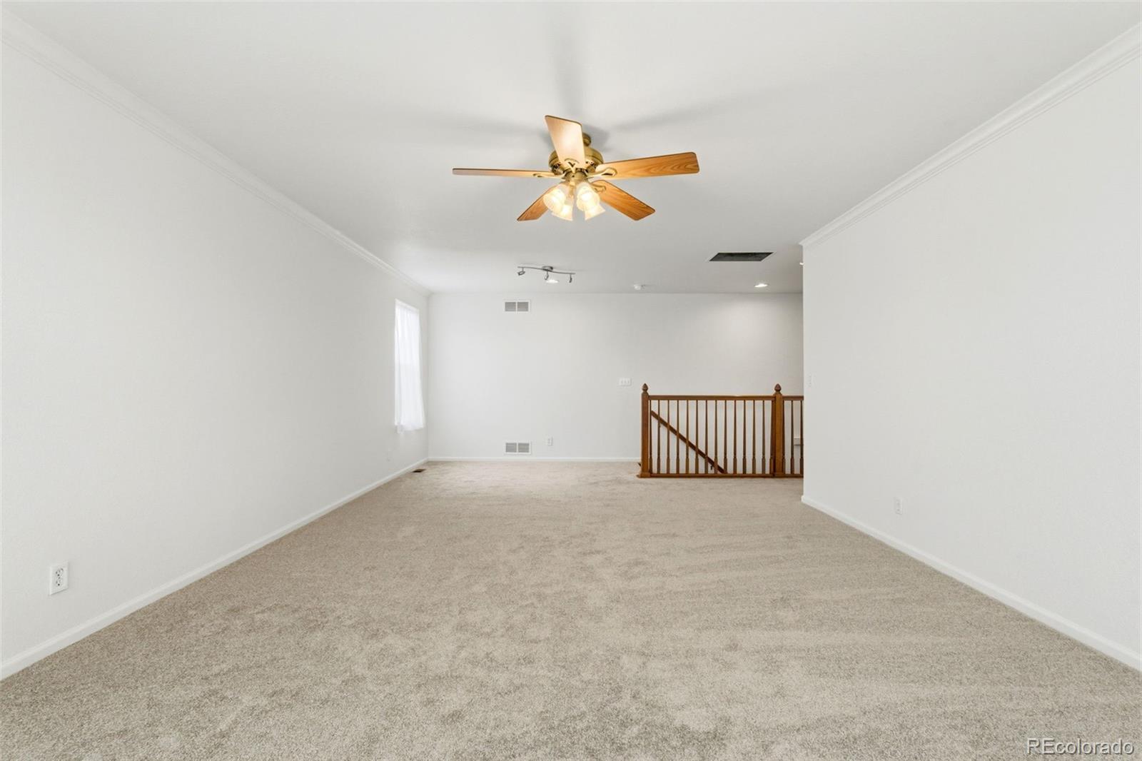 3033 East 108th Drive Northglenn, CO 80233 - Photo 16 of 50 a view of a ceiling fan and a projector