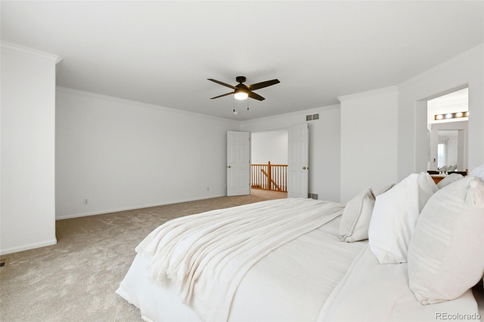 3033 East 108th Drive Northglenn, CO 80233 - Photo 19 of 50 a bedroom with a bed and a ceiling fan