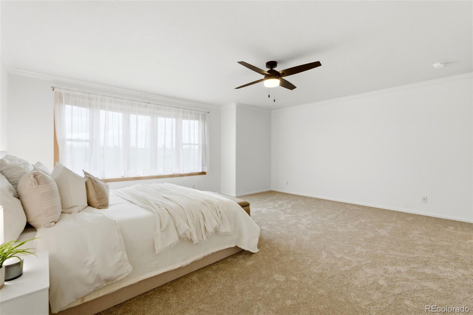 3033 East 108th Drive Northglenn, CO 80233 - Photo 20 of 50 a bedroom with a bed and a window
