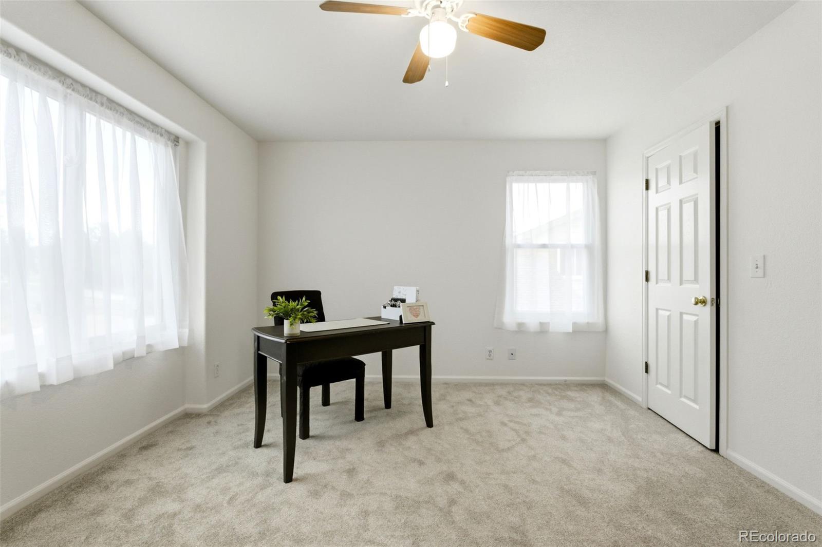 3033 East 108th Drive Northglenn, CO 80233 - Photo 24 of 50 a workspace with furniture and window